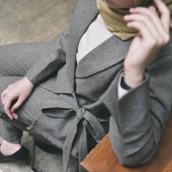 Professional fashion shot featuring a gray suit and headscarf, perfect for business settings.